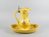 a yellow plate with a yellow pitcher on it