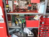 a red fire hydrant in a garage with a lot of tools