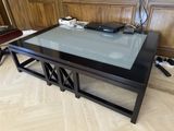 a glass table with a remote on top of it