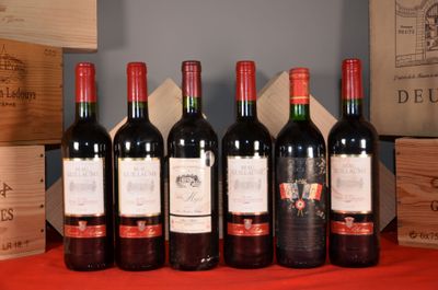 six bottles of red wine are lined up on a table