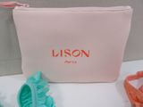 a pink bag with a pair of shoes next to it