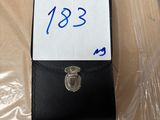 a small black wallet with a price tag on it