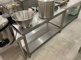 many pots and pans sitting on a stainless steel table