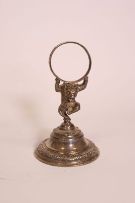 an image of a silver plate with a ring on it