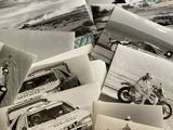 several old black and white photos of people and vehicles on a bed