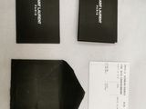 two black boxes and a white card sitting on top of a table