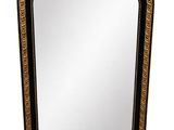 a black and gold mirror with a decorative design on it