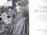 an open book with a drawing of a man in a black robe
