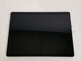 the back of a black tablet computer sitting on top of a white surface