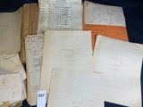some old papers are stacked on top of each other on a table