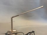 an image of a desk lamp and charger on a table
