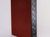 a red book sitting on top of a white surface