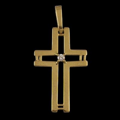 a gold cross pendant with a diamond in the center