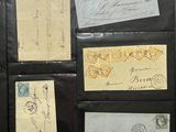 a black folder with a lot of old postcards on it