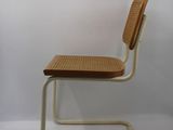 an image of a chair with a wicker seat and back