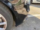 a close up of a car ' s front bumper and tire