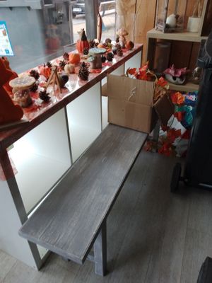 a table with a bench in front of a window