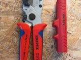 two pliers that are laying on a wooden surface