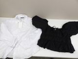 a white shirt and a black shirt sitting on a table