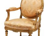 an image of a chair with a gold upholstered upholstered back and arms