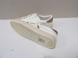 white sneakers with gold glitters on them on a white surface