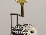 an elephant statue with a lamp on top of it