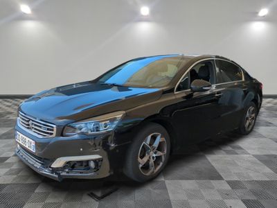 the black car is parked on a checkered floor in the garage