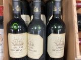 several bottles of wine are in a cardboard box on a counter