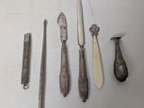 five different types of knives and spoons on the table