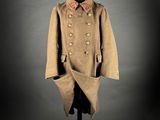 a coat on a mannequin stand with a black background