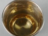a silver cup that is sitting on a table
