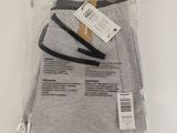 two pairs of men ' s grey pants in a plastic bag