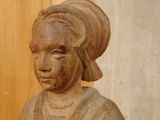 a statue of a woman sitting on a table