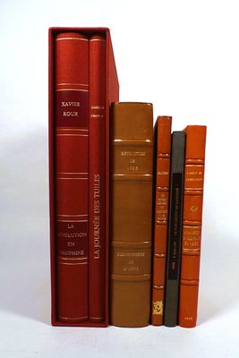 several books are lined up in a row on a white surface