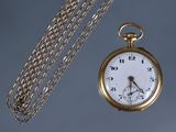 a gold pocket watch with a chain around it