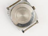 an old silver watch with a metal band on a white surface