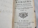 an old book that is open on a table