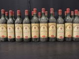 six bottles of wine are lined up in a row on a table