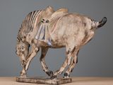 a statue of a horse that is standing on a table