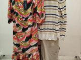 two women ' s dresses are on display in a clothing store