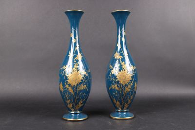 pair of blue and gold vases sitting on top of a table