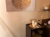 a picture of a bathroom with a large picture on the wall