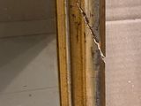 a mirror with a chain hanging from it and a person ' s hand holding it