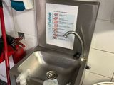 a sink with a bottle of water in the corner of the room