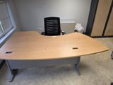 a desk with a chair in the corner of the room
