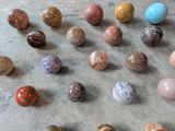a lot of different colored marbles on the floor