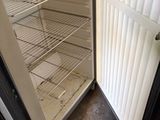 an open refrigerator with a bucket of food inside of it