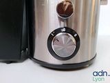 a close up of a stainless steel blender on a counter