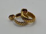 a close up of a gold ring on a white surface
