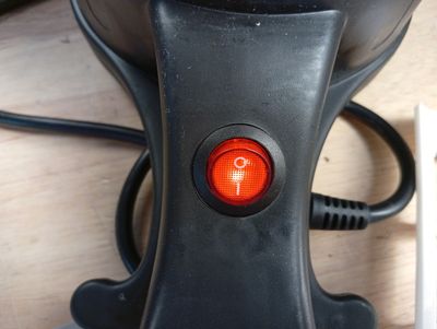 a close up of a red light on a black object